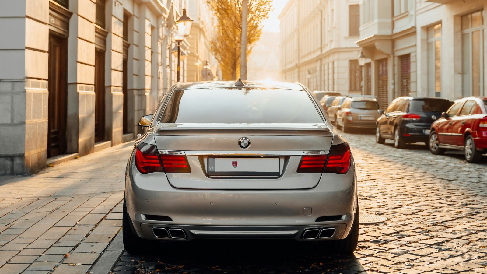 Silver car parked on a cobblestone street