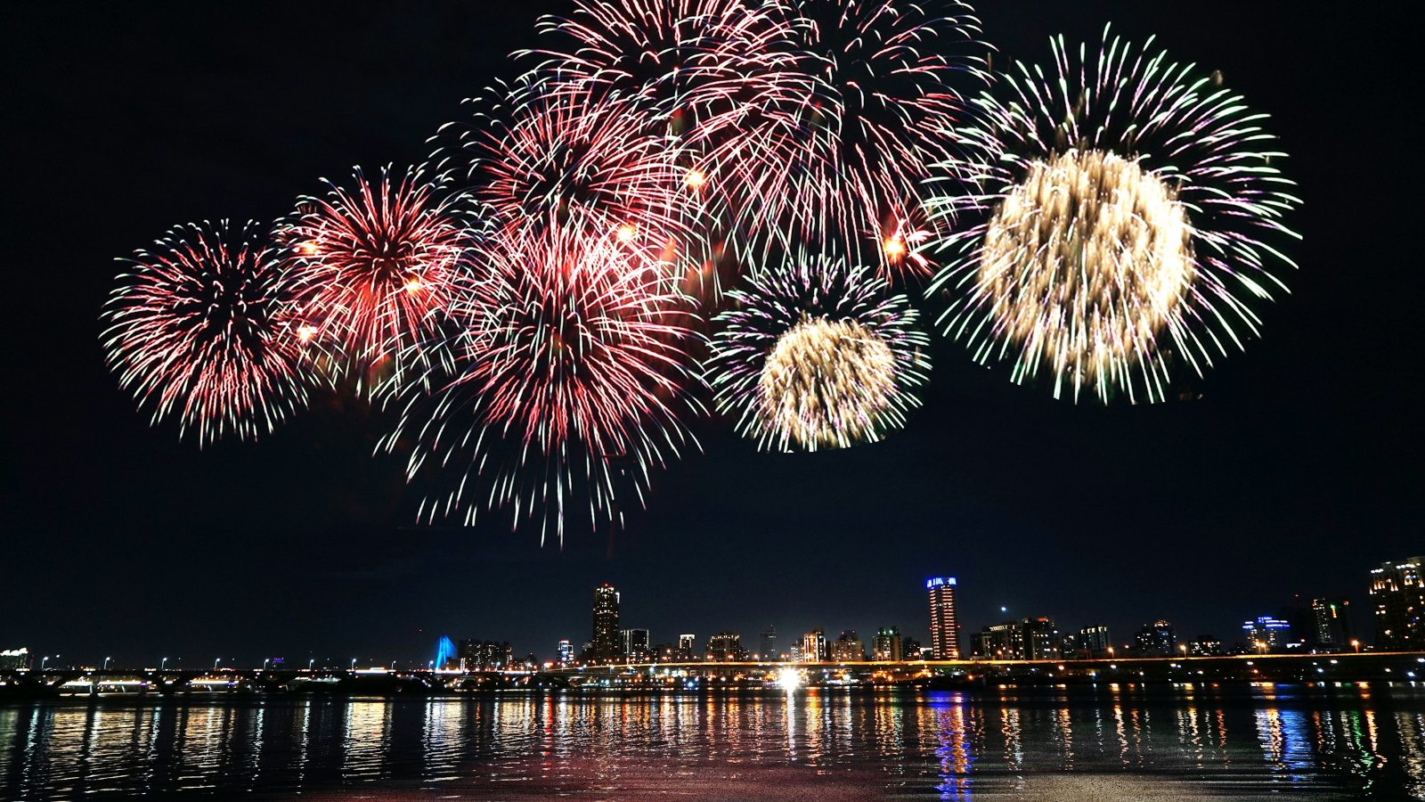 Fireworks over a city skyline at night
