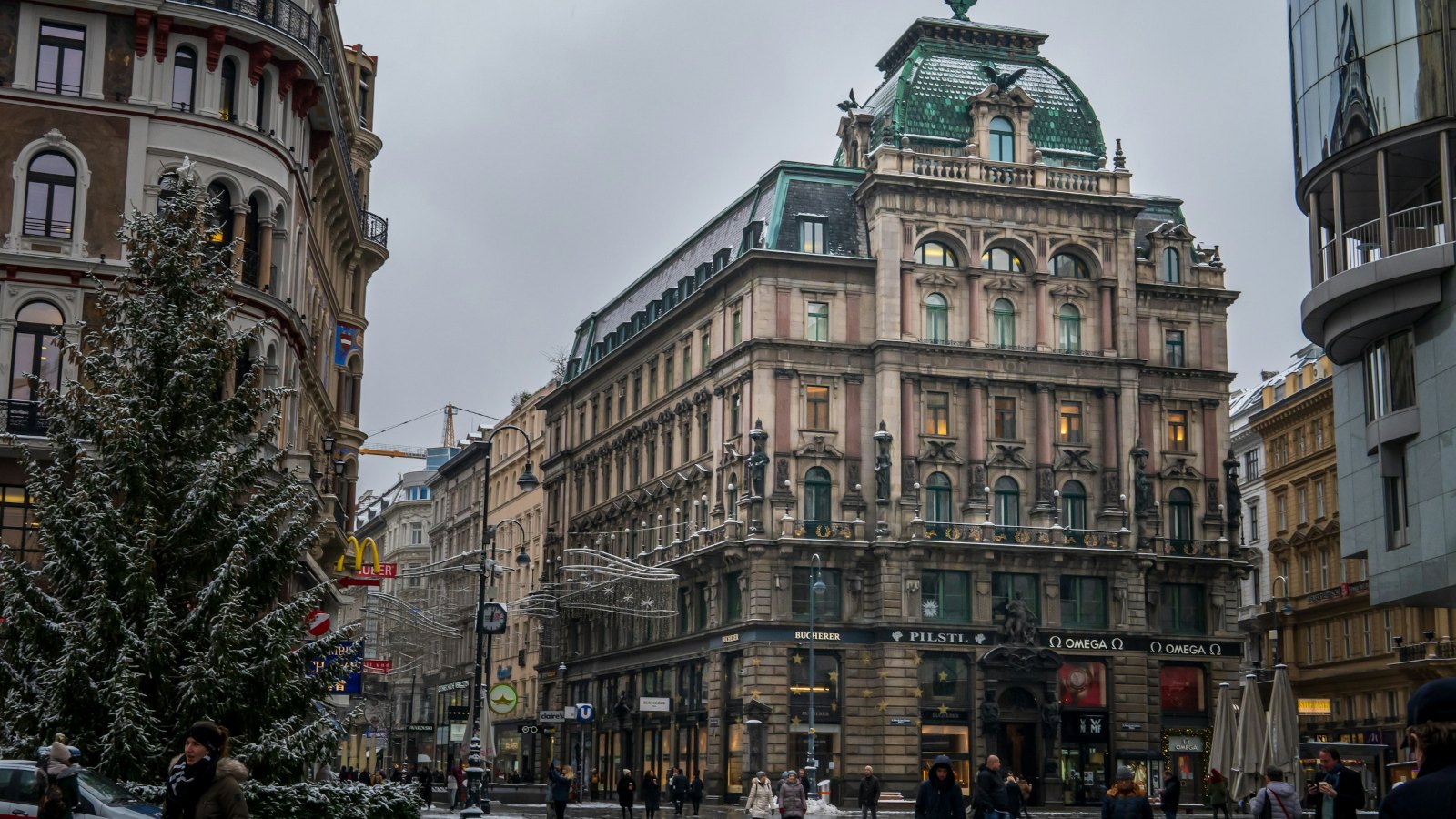 Snowy street in Vienna with a Christmas tree