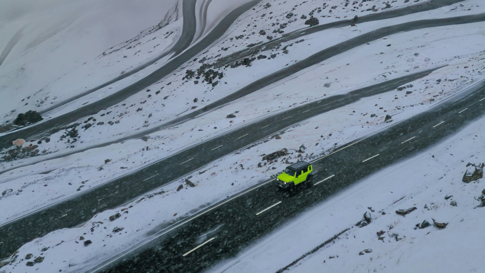 Snowy winter road with a car